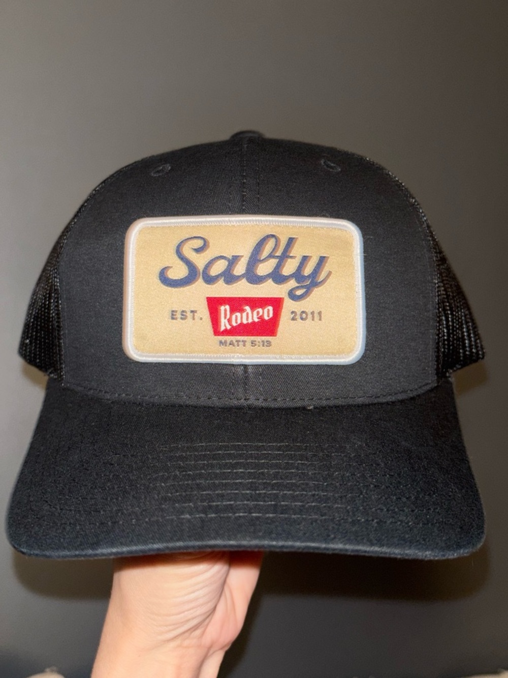 Salty Crew Black Trucker Hat with Tan Patch and Red Accent